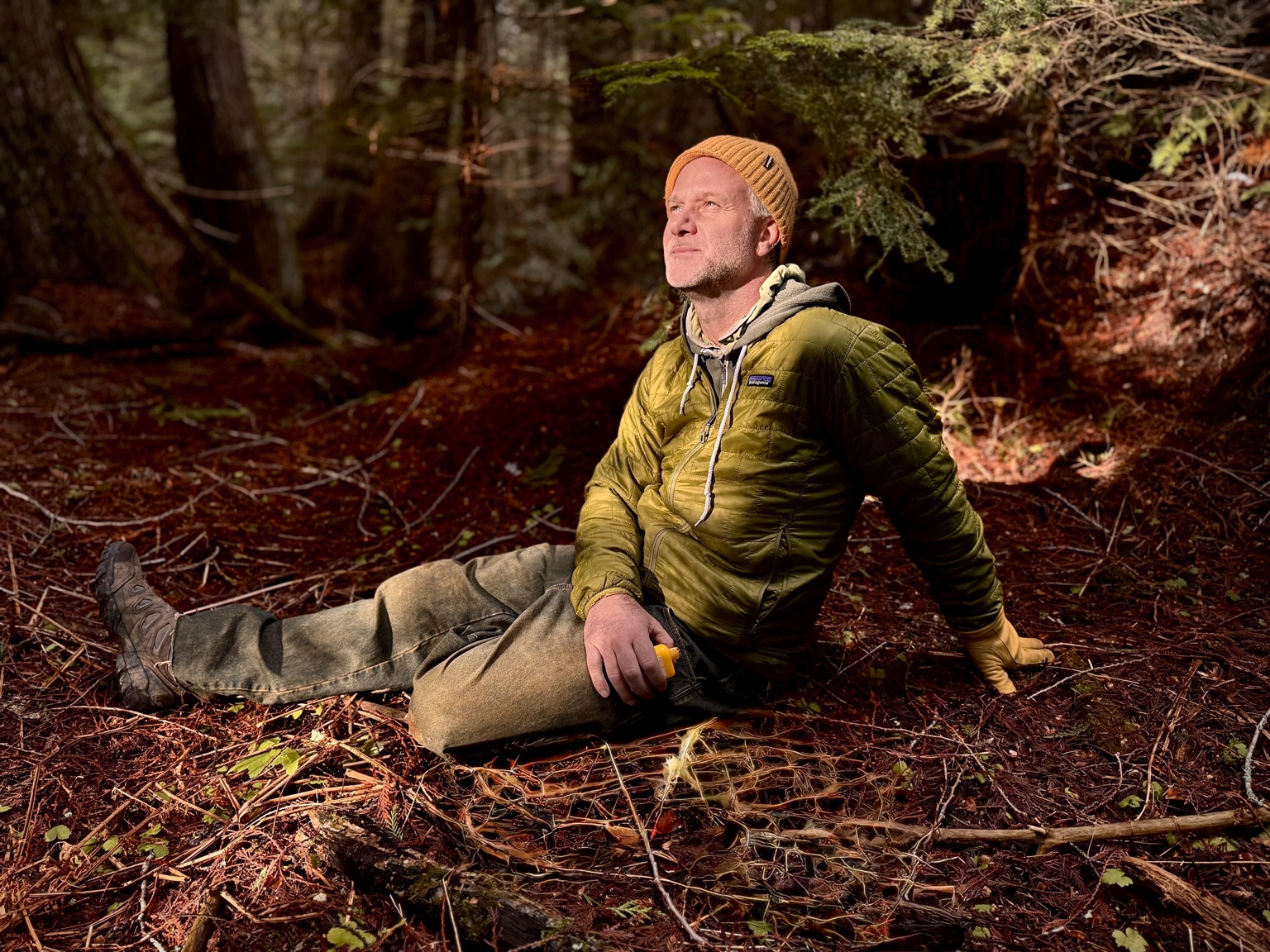 Harry G. Neff sitting in a sunlit forest